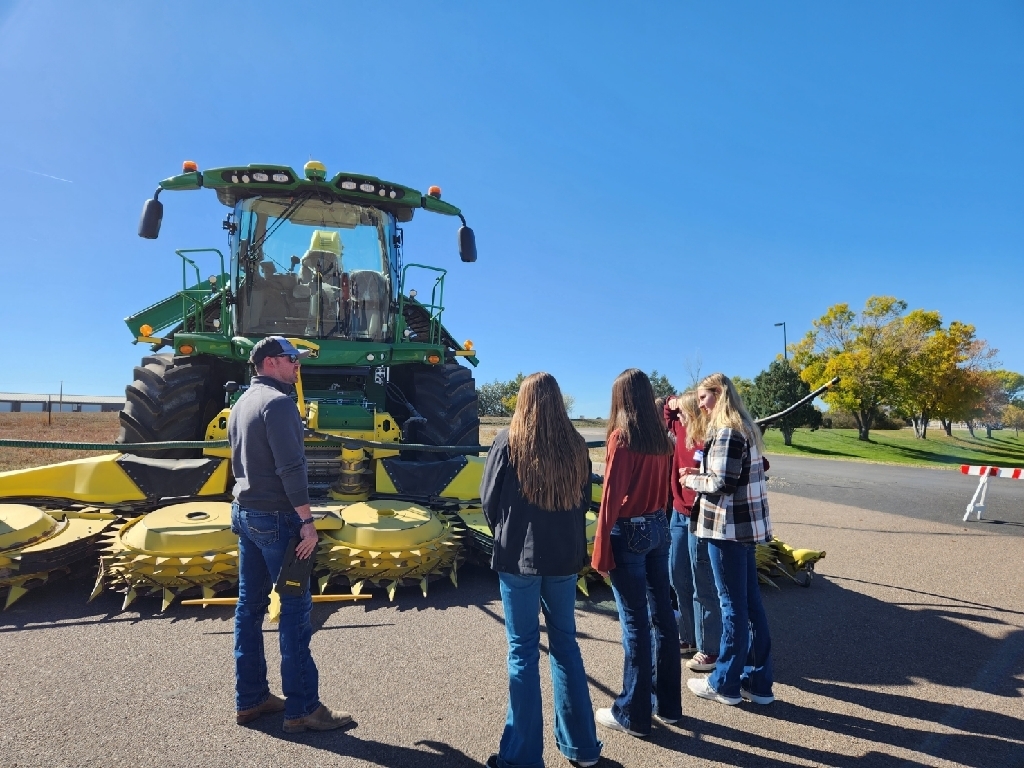 Students listening to a speaker about Ag equipment. 