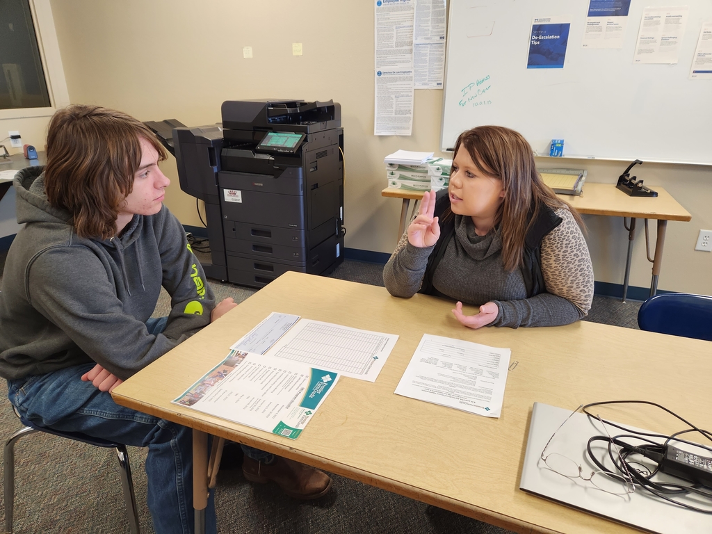 Two people meeting and discussing a grant program 